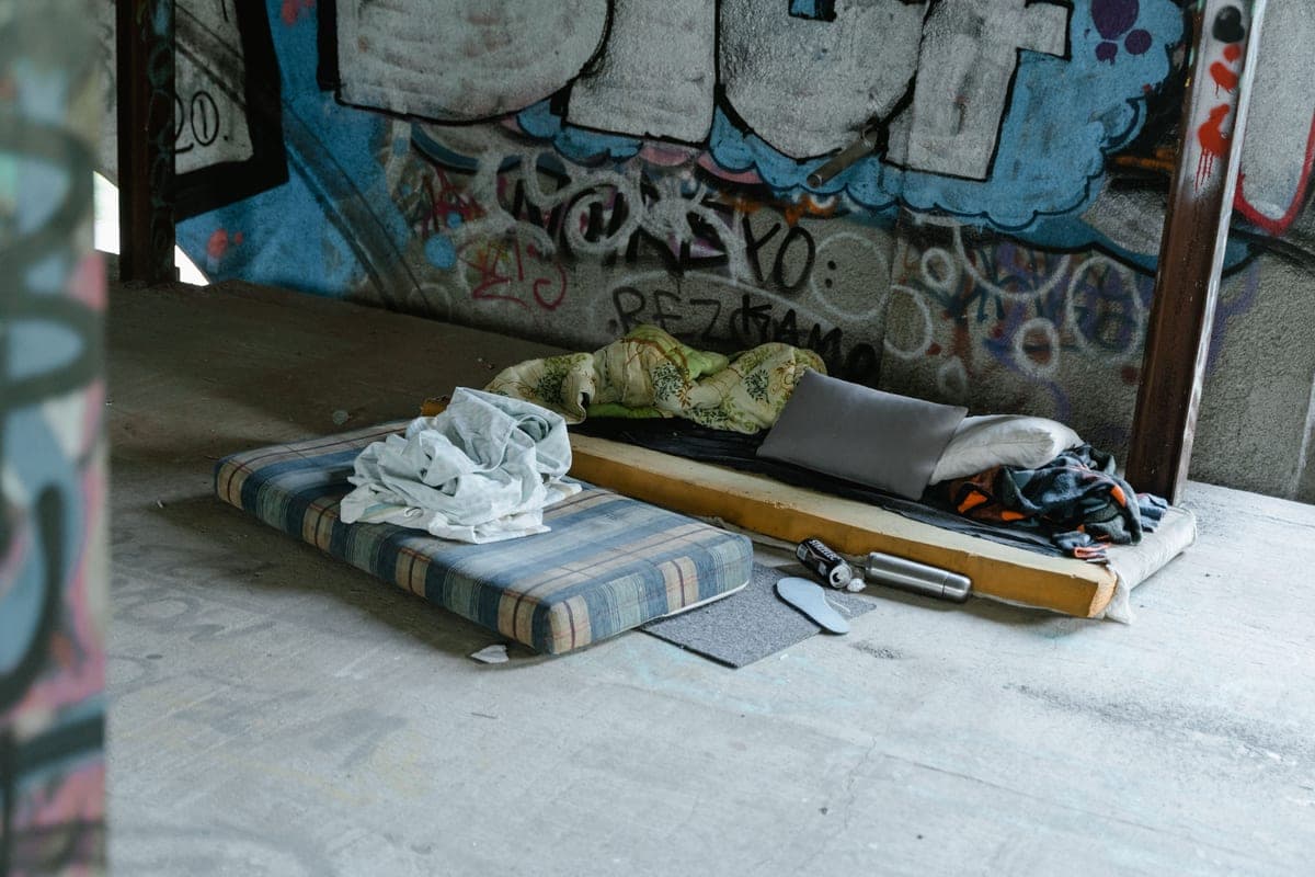 A folded block of foam mattress standing on a hard floor