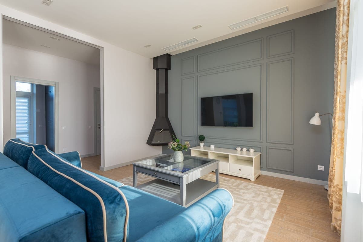 A narrow living room with seating close against one wall